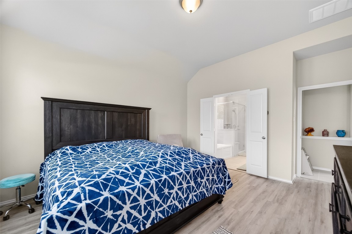 2739 Meadow View Lane Conroe, TX 77385 - Photo 32 of 50 a bedroom with a bed and wooden floor