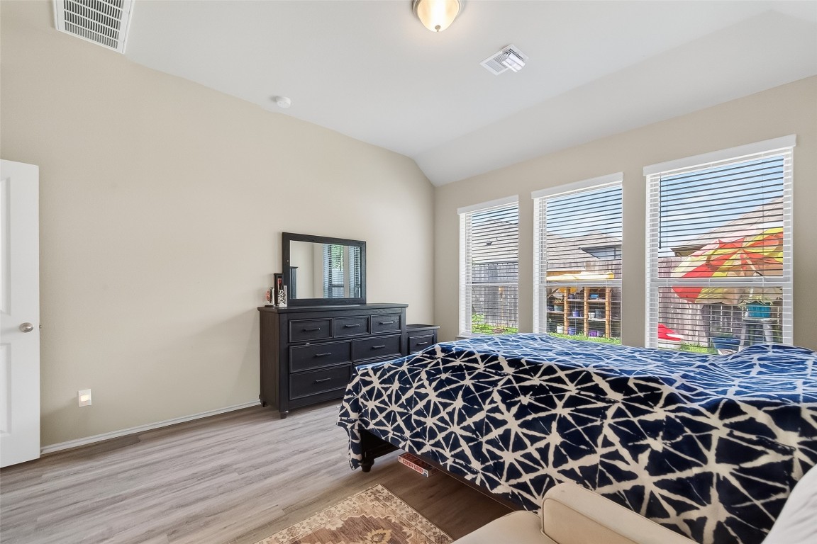 2739 Meadow View Lane Conroe, TX 77385 - Photo 33 of 50 a bedroom with a bed and wooden floor