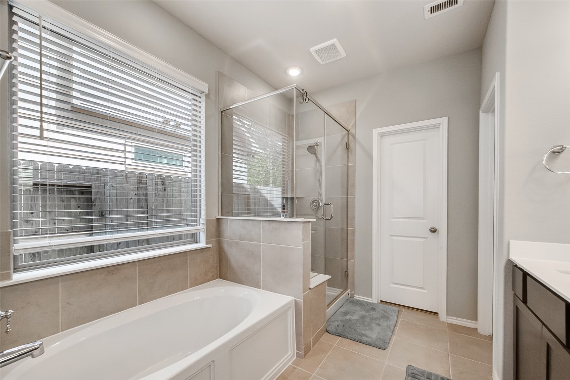 2739 Meadow View Lane Conroe, TX 77385 - Photo 35 of 50 a bathroom with a bathtub and a shower