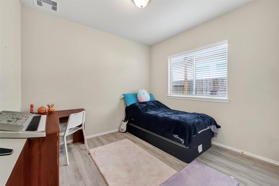 2739 Meadow View Lane Conroe, TX 77385 - Photo 38 of 50 a bedroom with a bed and wooden floor