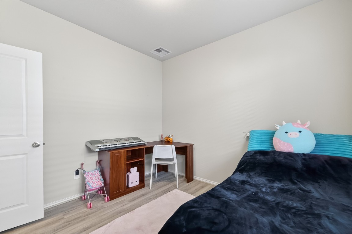 2739 Meadow View Lane Conroe, TX 77385 - Photo 39 of 50 a bedroom with bed and a fireplace