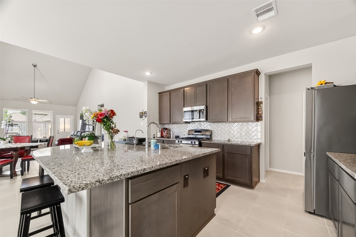 2739 Meadow View Lane Conroe, TX 77385 - Photo 5 of 50 a kitchen with stainless steel appliances granite countertop a sink dishwasher and refrigerator