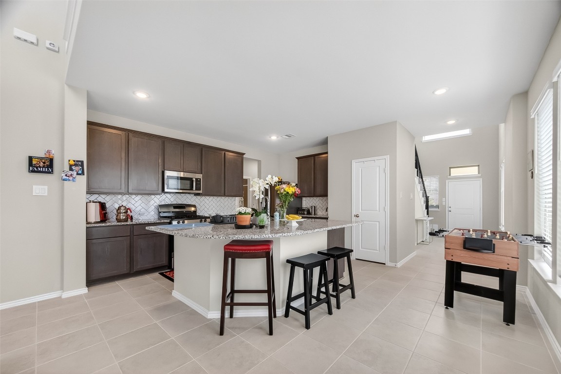 2739 Meadow View Lane Conroe, TX 77385 - Photo 7 of 50 a kitchen with kitchen island a dining table and chairs