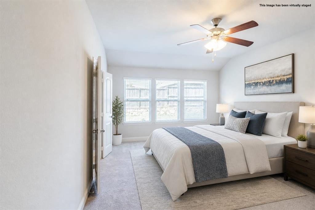 516 Hunt Farms Road Fate, TX 75189 - Photo 22 of 40 Virtual staged=>Vaulted ceiling with a ceiling fan, light-colored carpeting, and a series of three windows