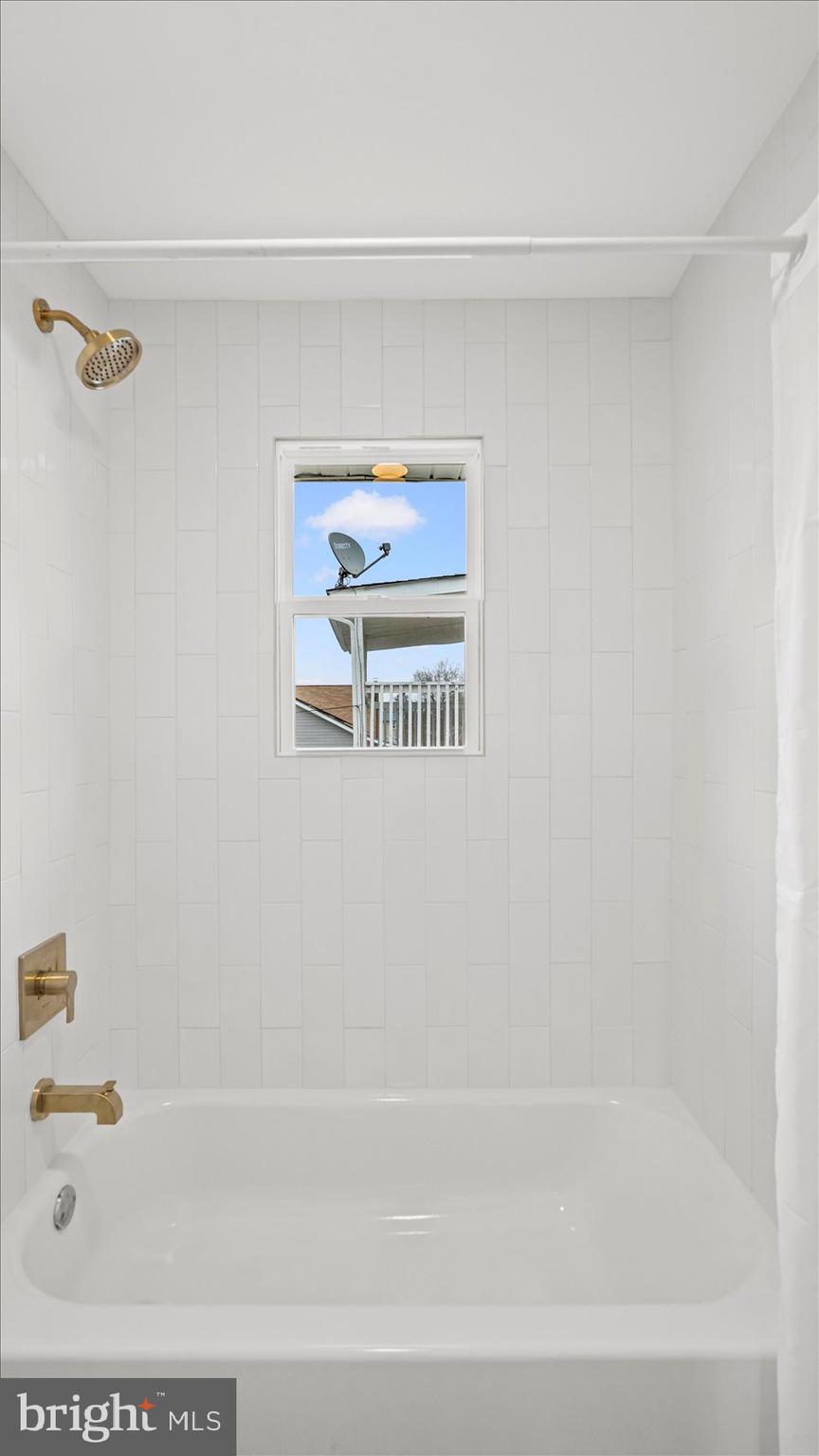 4817 Valley Forge Road Randallstown, MD 21133 - Photo 12 of 36 a bathroom with a bathtub and a shower