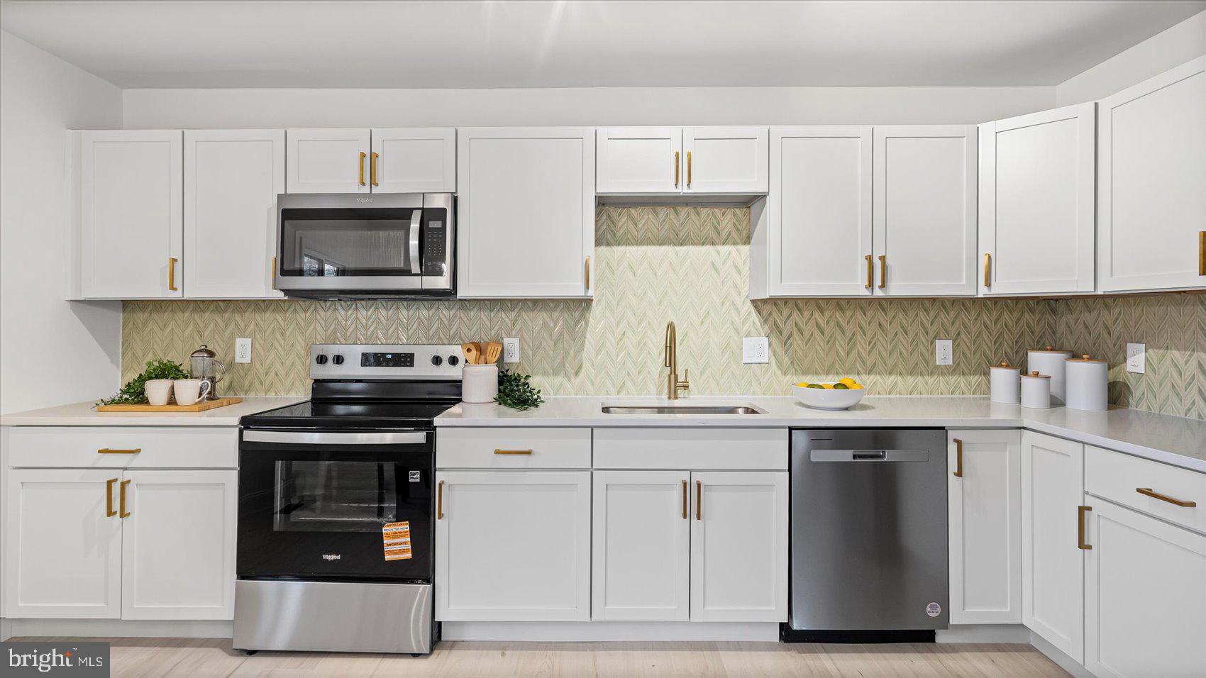 4817 Valley Forge Road Randallstown, MD 21133 - Photo 25 of 36 a kitchen with stainless steel appliances granite countertop a stove a sink and a white cabinets