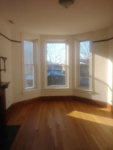 a view of room with window and hardwood floor