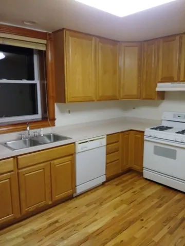a kitchen with a sink cabinets and appliances