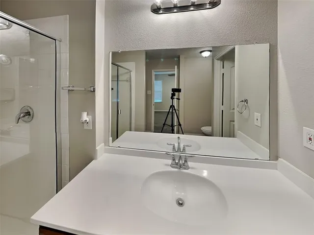 a bathroom with a glass shower door