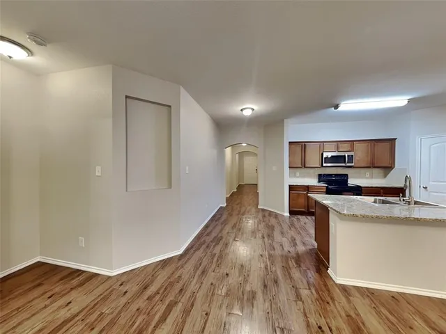 a view of kitchen with sink microwave and stove