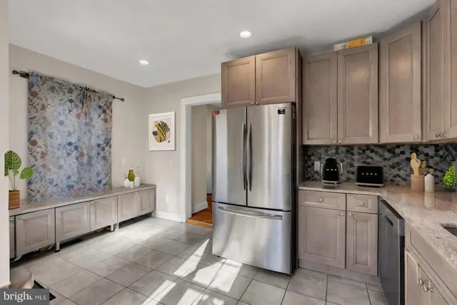a kitchen with a refrigerator and a sink