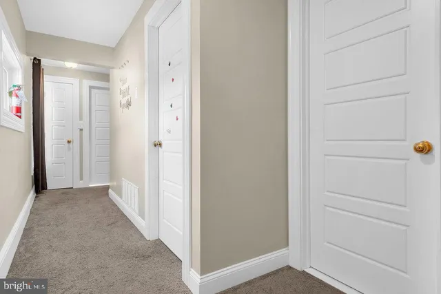 a view of a hallway to rooms