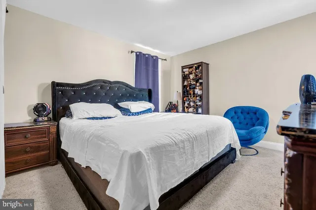 a bedroom with a bed and dresser