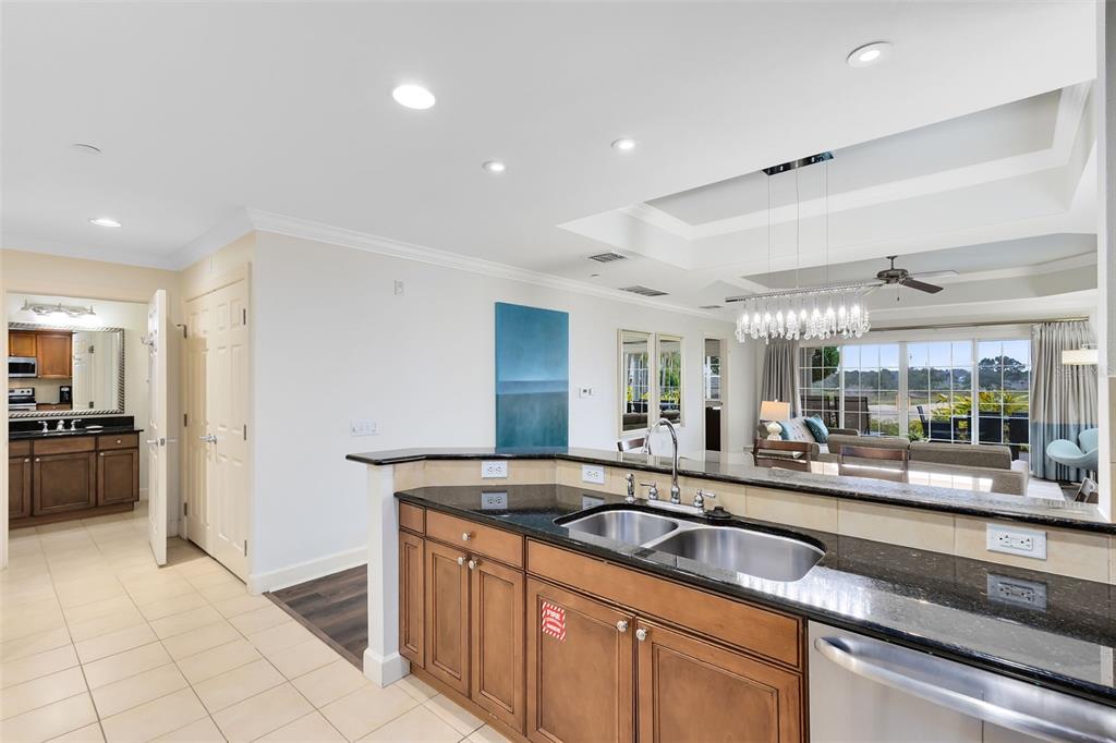 1368 Centre Ct Ridge Drive, Unit 104 Reunion, FL 34747 - Photo 12 of 33 a large kitchen with granite countertop a sink and a refrigerator