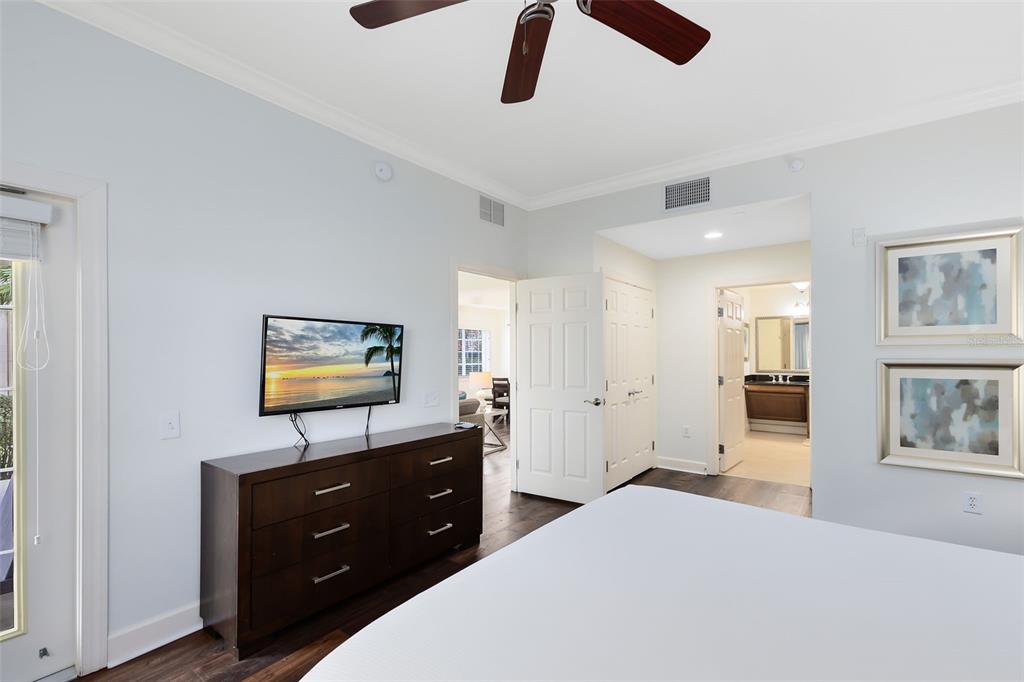1368 Centre Ct Ridge Drive, Unit 104 Reunion, FL 34747 - Photo 15 of 33 a bedroom with a bed and a flat screen tv