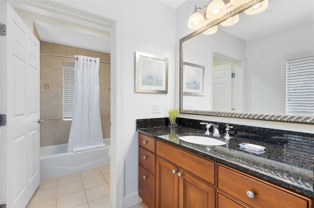 1368 Centre Ct Ridge Drive, Unit 104 Reunion, FL 34747 - Photo 20 of 33 a bathroom with a sink and a mirror