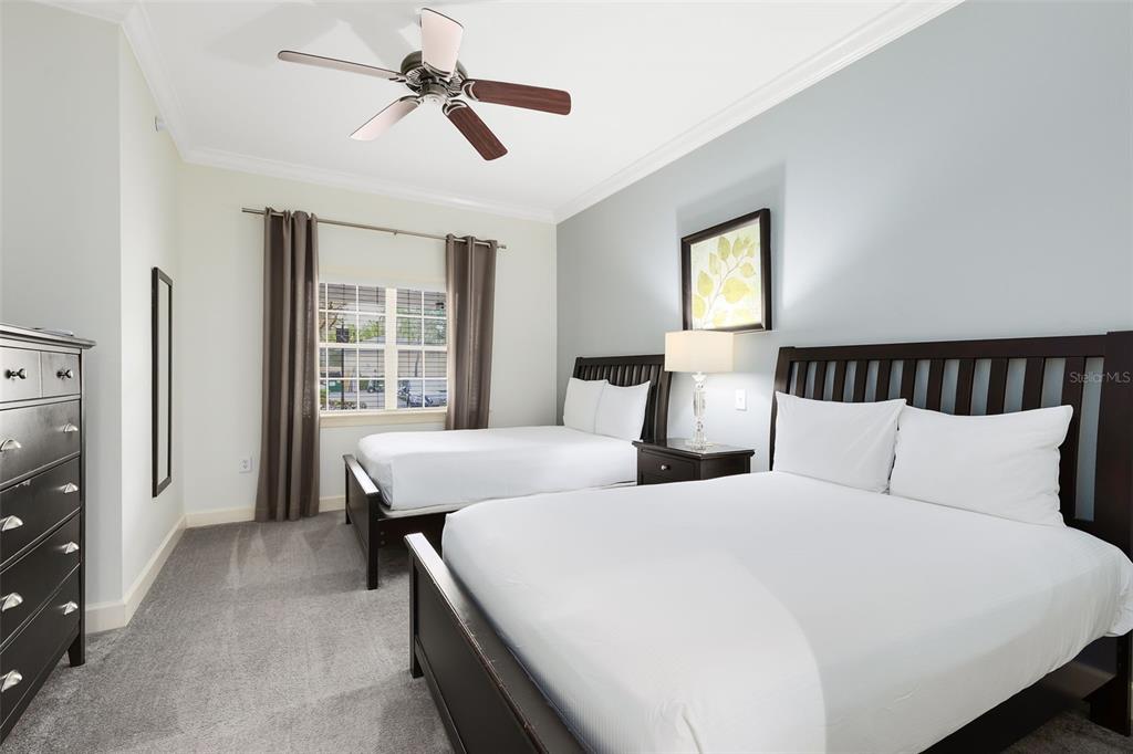 1368 Centre Ct Ridge Drive, Unit 104 Reunion, FL 34747 - Photo 21 of 33 a bedroom with double bed and a window