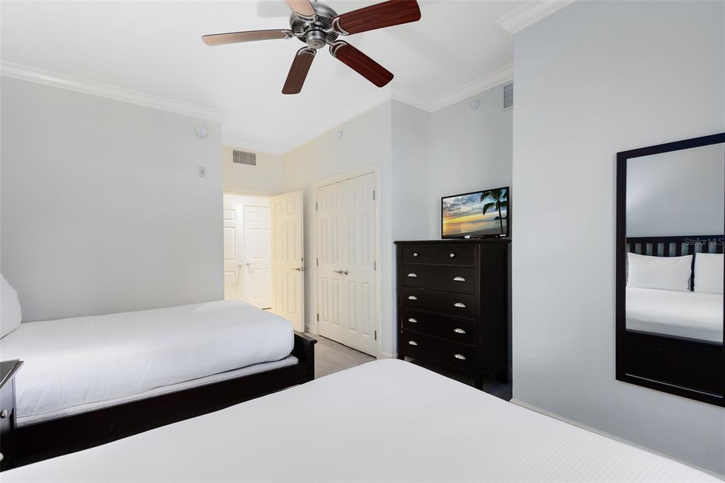 1368 Centre Ct Ridge Drive, Unit 104 Reunion, FL 34747 - Photo 22 of 33 a bedroom with a bed and a closet