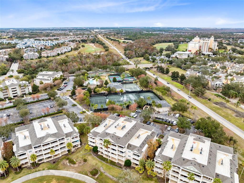 1368 Centre Ct Ridge Drive, Unit 104 Reunion, FL 34747 - Photo 31 of 33 an aerial view of residential building with parking