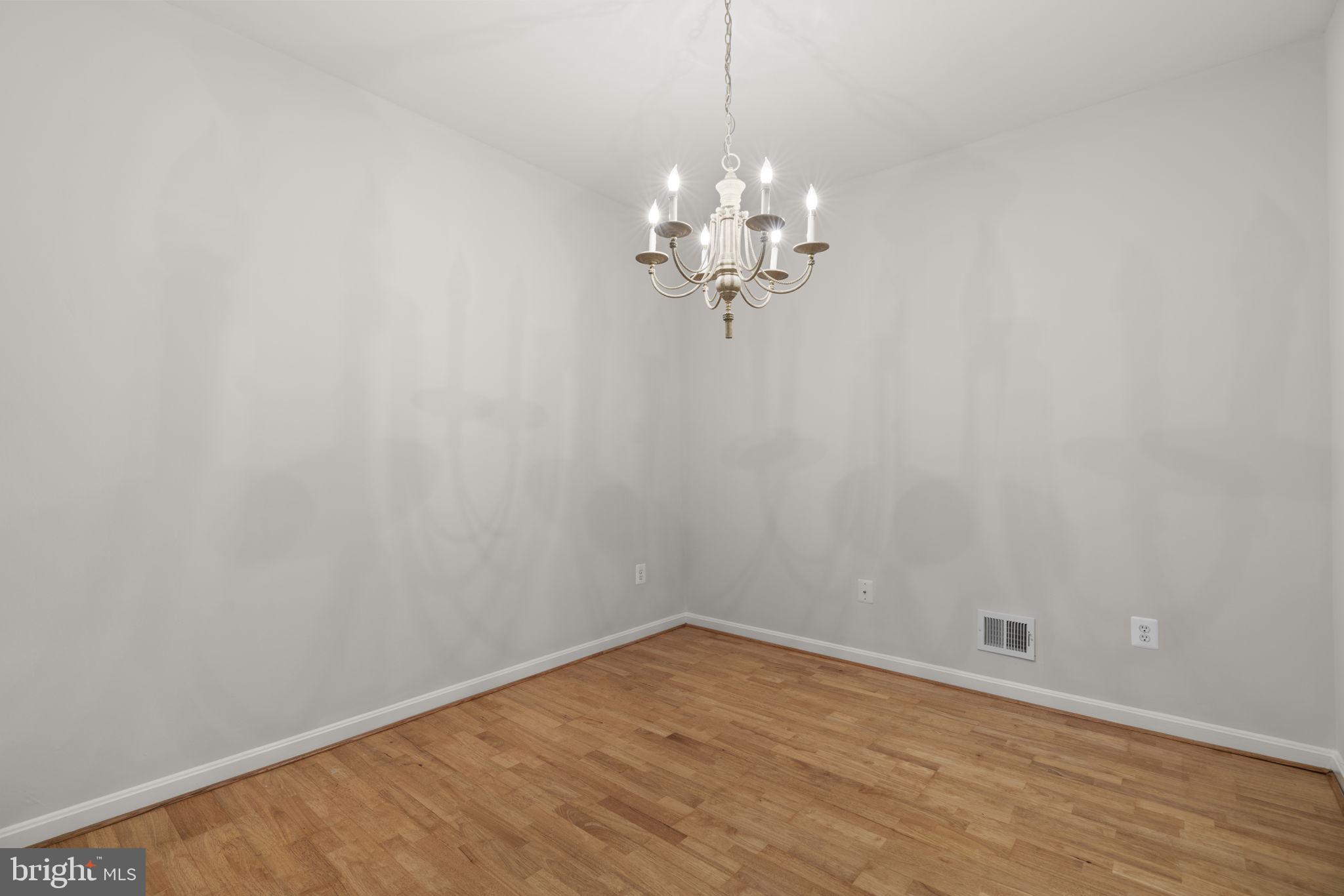 7315 Maplecrest Road, Unit 104 Elkridge, MD 21075 - Photo 15 of 58 a view of a room with wooden floor and fan