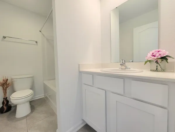 a bathroom with a sink toilet and a mirror
