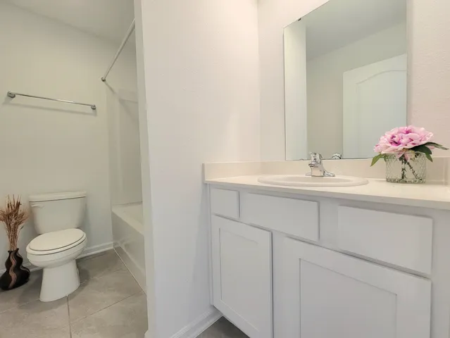a bathroom with a sink toilet and a mirror