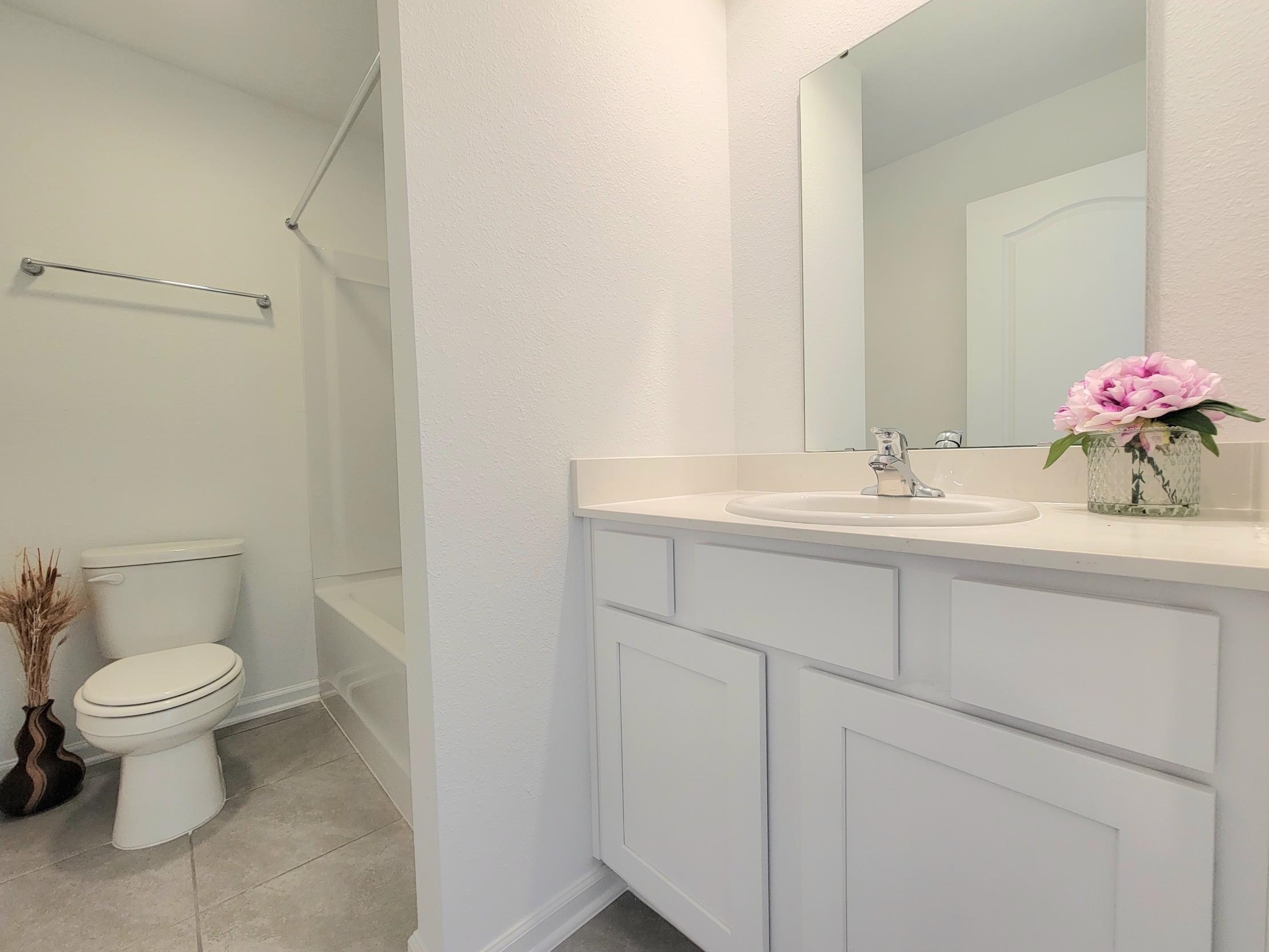 177 Tidal Bch Avenue St. Augustine, FL 32095 - Photo 3 of 39 a bathroom with a sink toilet and a mirror