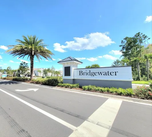 a view of a street with a building and a street sign