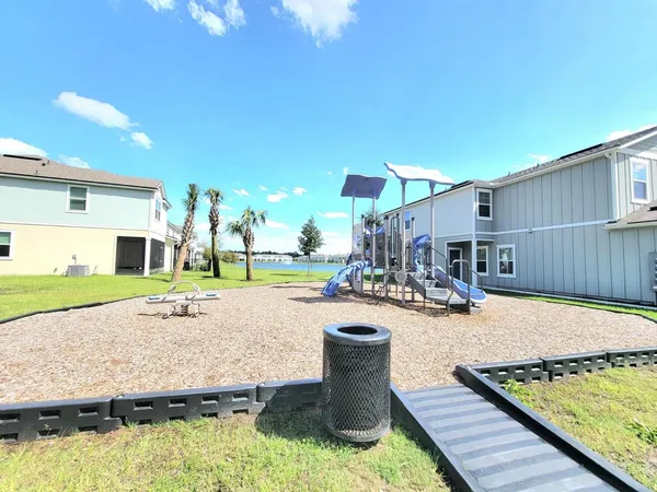 a swimming pool with outdoor seating and yard
