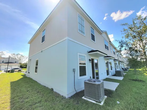 a view of a house with backyard and porch