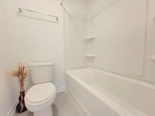 a bathroom with a toilet and a bathtub