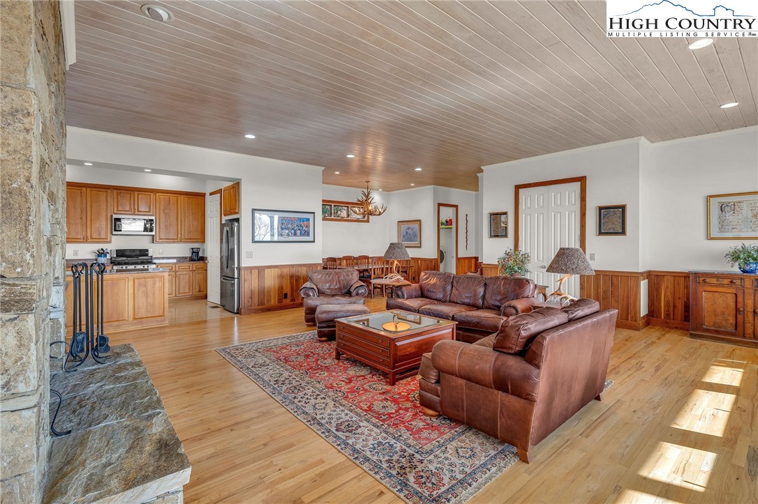 933 Thunder Ridge Lane Lenoir, NC 28645 - Photo 11 of 45 a living room with furniture wooden floor and kitchen view