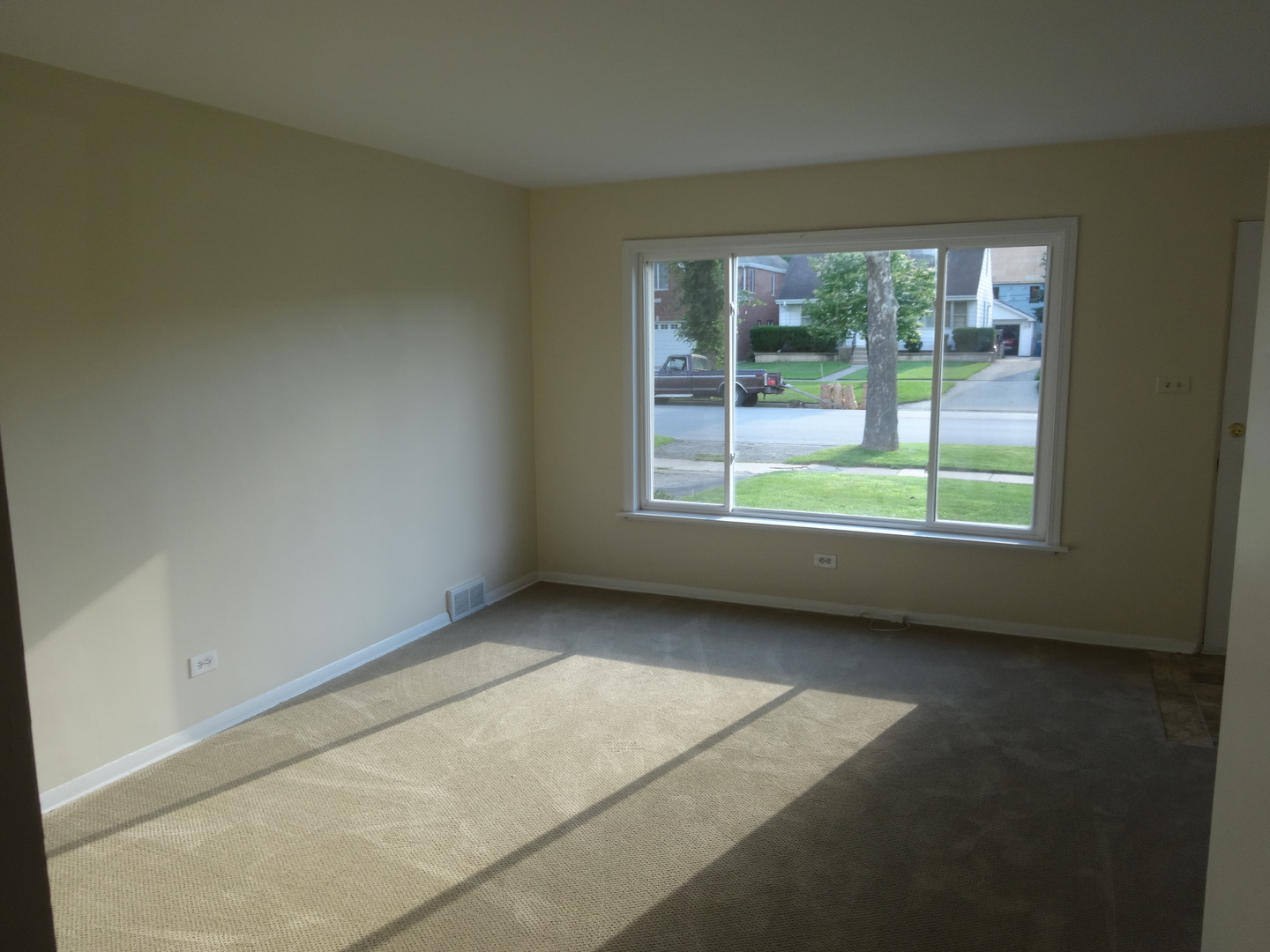 961 Spring Road Elmhurst, IL 60126 - Photo 10 of 24 an empty room with wooden floor and windows