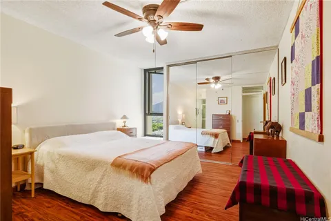a spacious bedroom with a bed and a chandelier