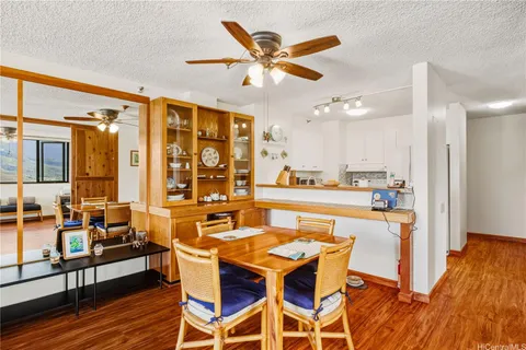 a dining room with furniture a chandelier and wooden floor