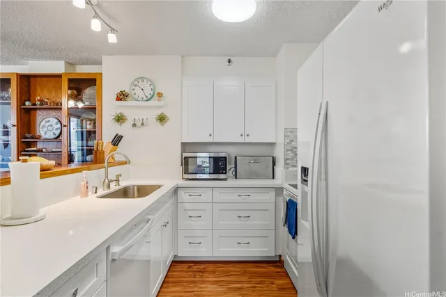 a kitchen with white cabinets and stainless steel appliances