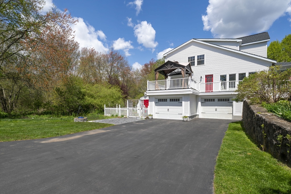 229 Parkerville Road Southborough, MA 01772 - Photo 9 of 38 a front view of a house with a yard and garage