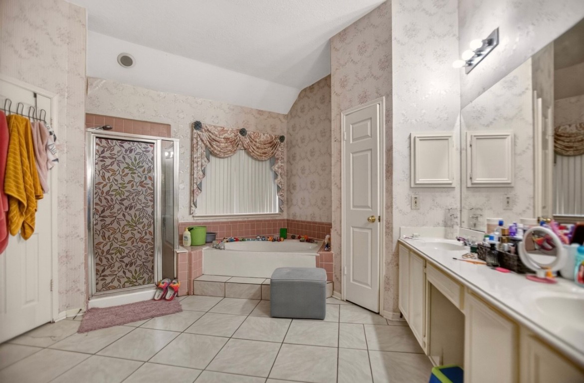 14731 Ridgechase Lane Houston, TX 77014 - Photo 13 of 29 a bathroom with a sink a toilet and shower