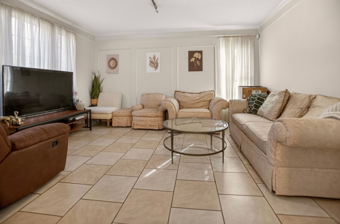 14731 Ridgechase Lane Houston, TX 77014 - Photo 3 of 29 a living room with furniture and a flat screen tv