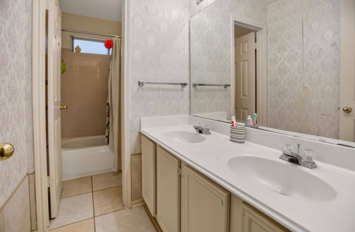 14731 Ridgechase Lane Houston, TX 77014 - Photo 8 of 29 a bathroom with a sink and a mirror