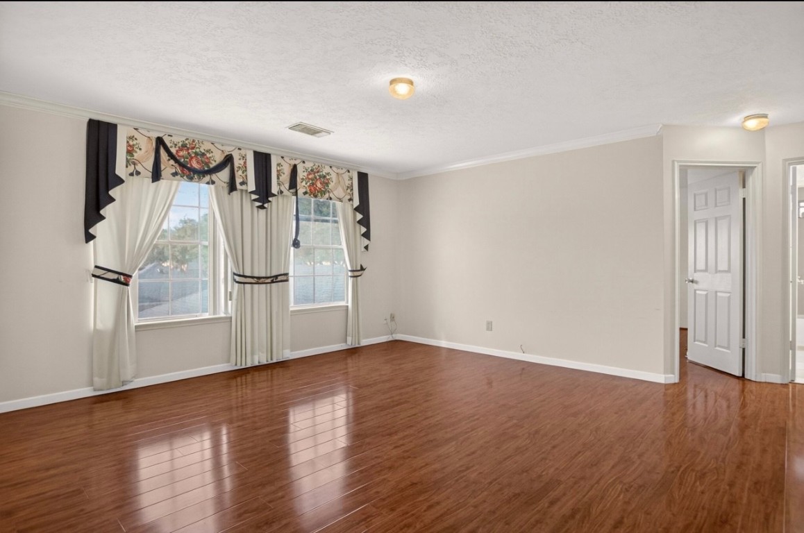 14731 Ridgechase Lane Houston, TX 77014 - Photo 10 of 29 an empty room with wooden floor and windows