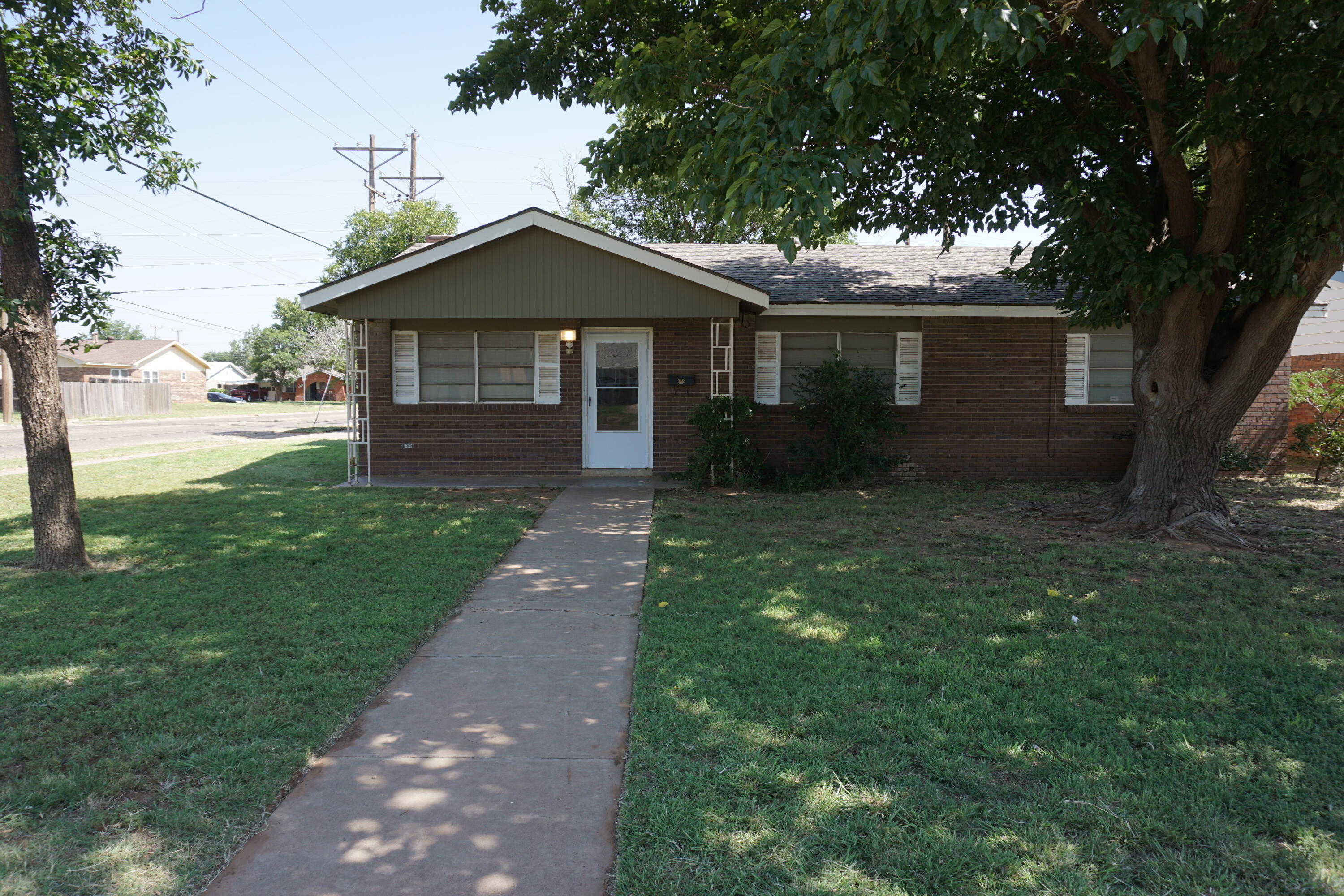 5416 36th Street Lubbock, TX 79407 - Photo 1 of 13 a front view of house with yard and green space