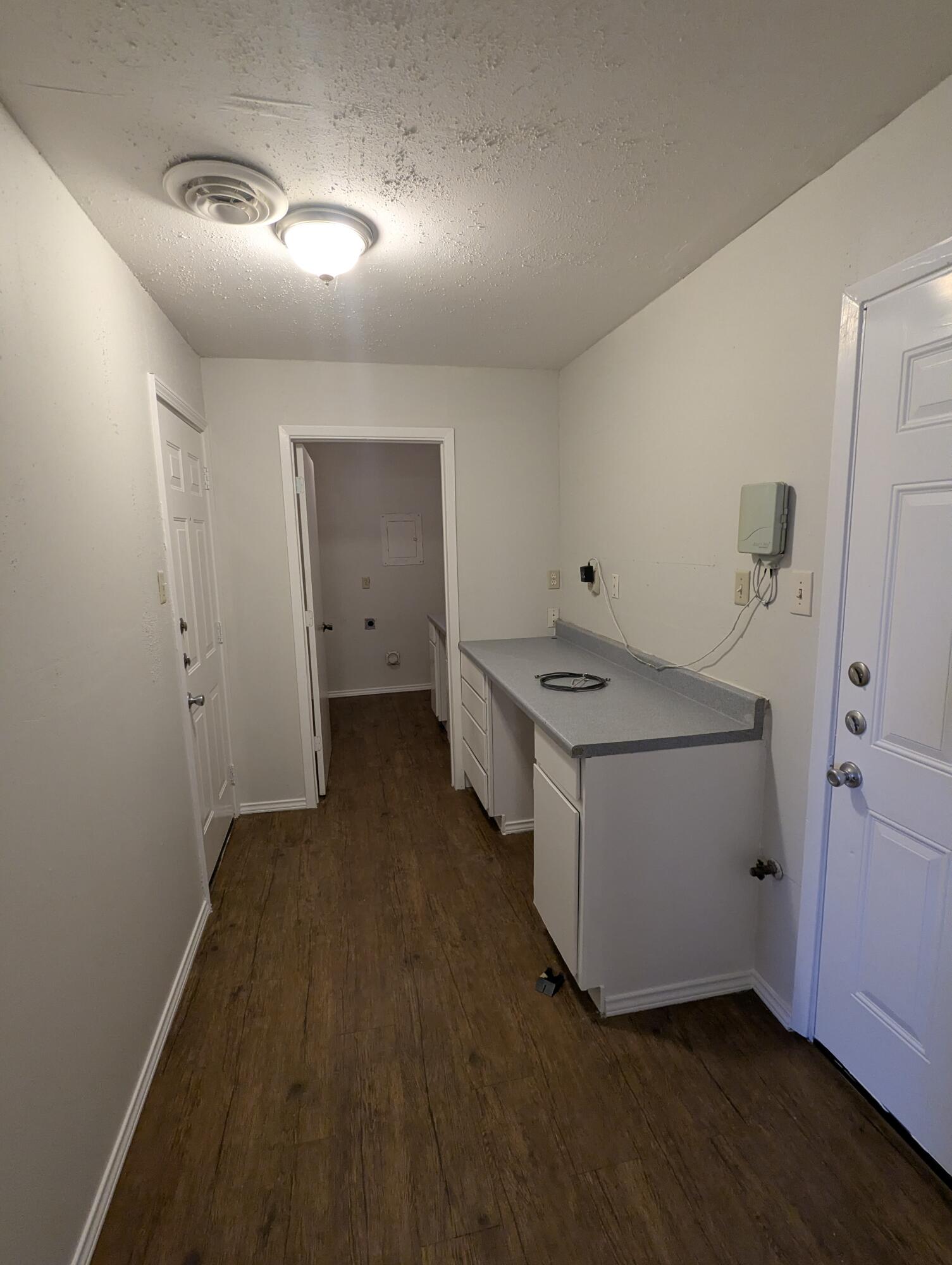 5416 36th Street Lubbock, TX 79407 - Photo 11 of 13 a utility room with cabinets washer and dryer