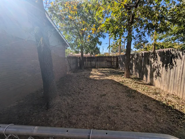 a view of a backyard with large trees