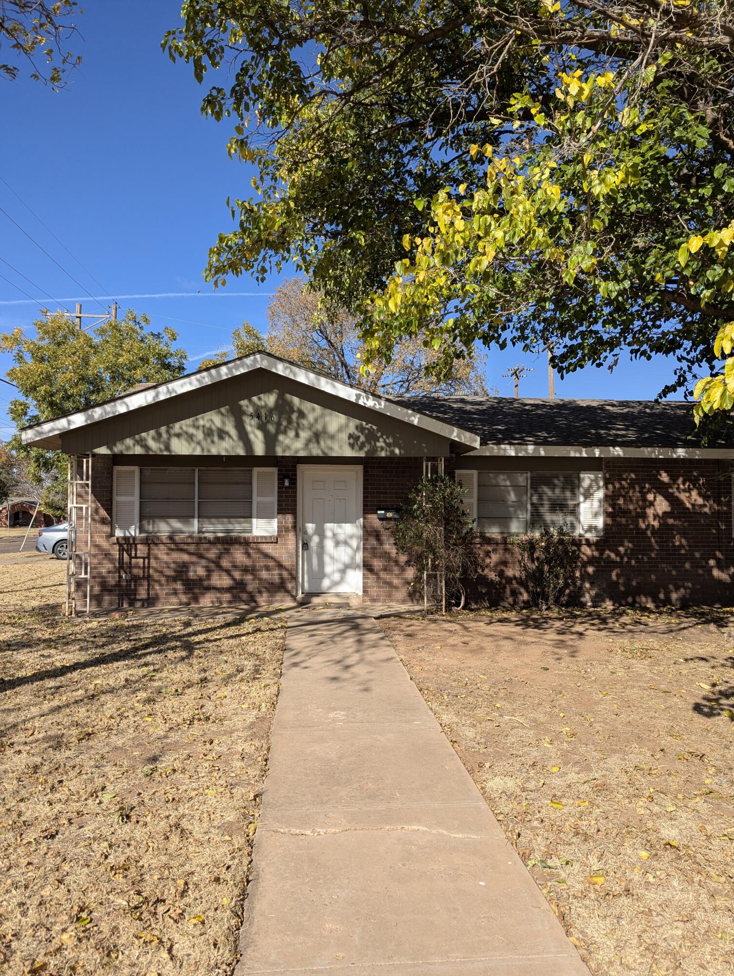 5416 36th Street Lubbock, TX 79407 - Photo 2 of 13 a front view of a house with a yard covered with snow