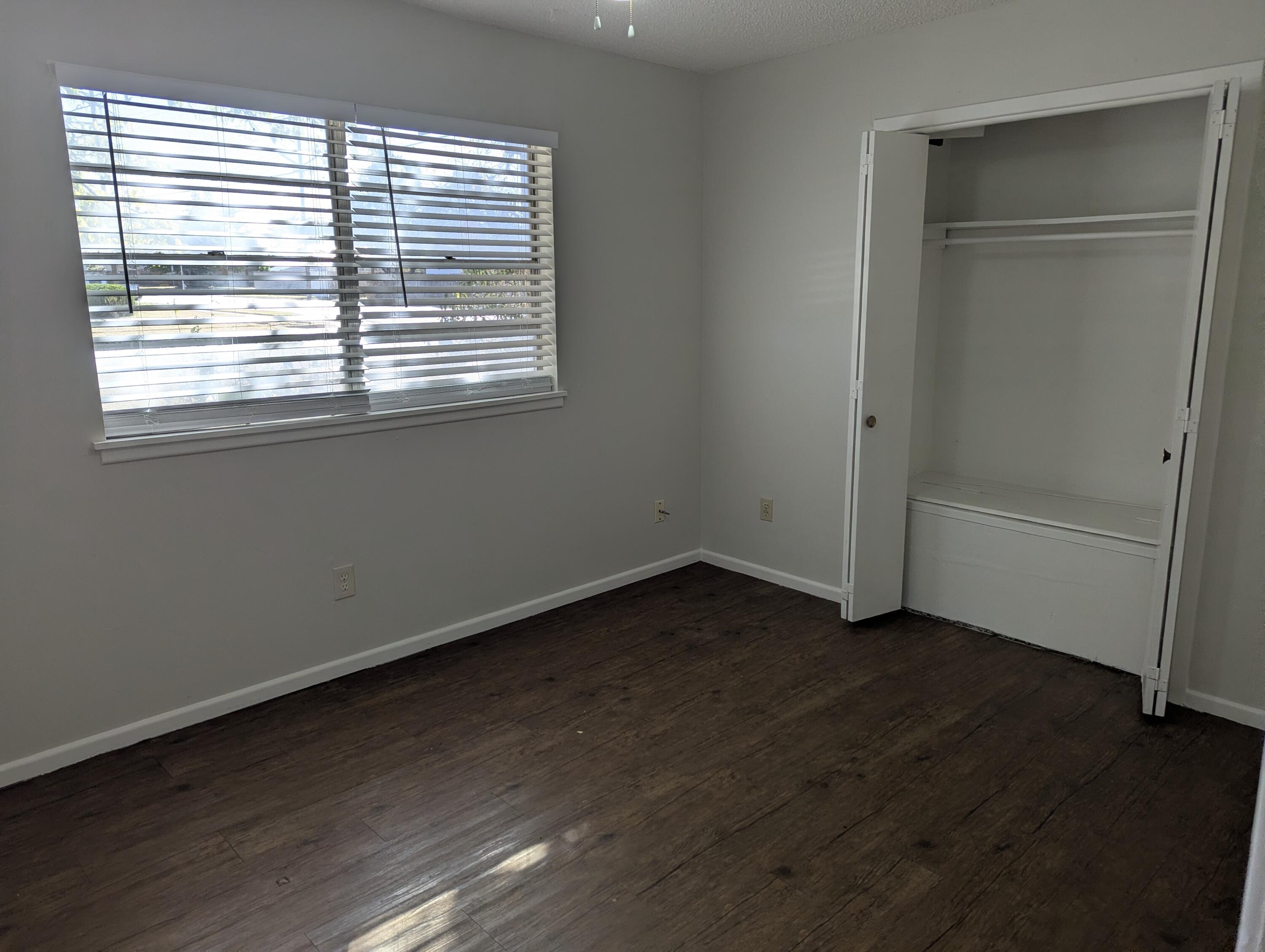 5416 36th Street Lubbock, TX 79407 - Photo 6 of 13 a view of an empty room with wooden floor and a window
