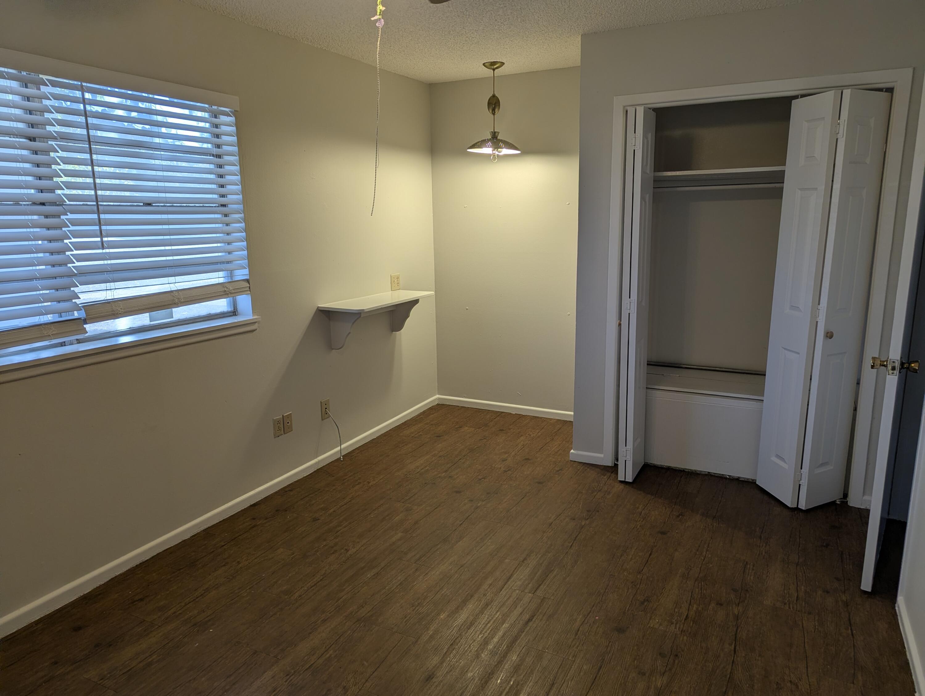 5416 36th Street Lubbock, TX 79407 - Photo 7 of 13 an empty room with wooden floor and door