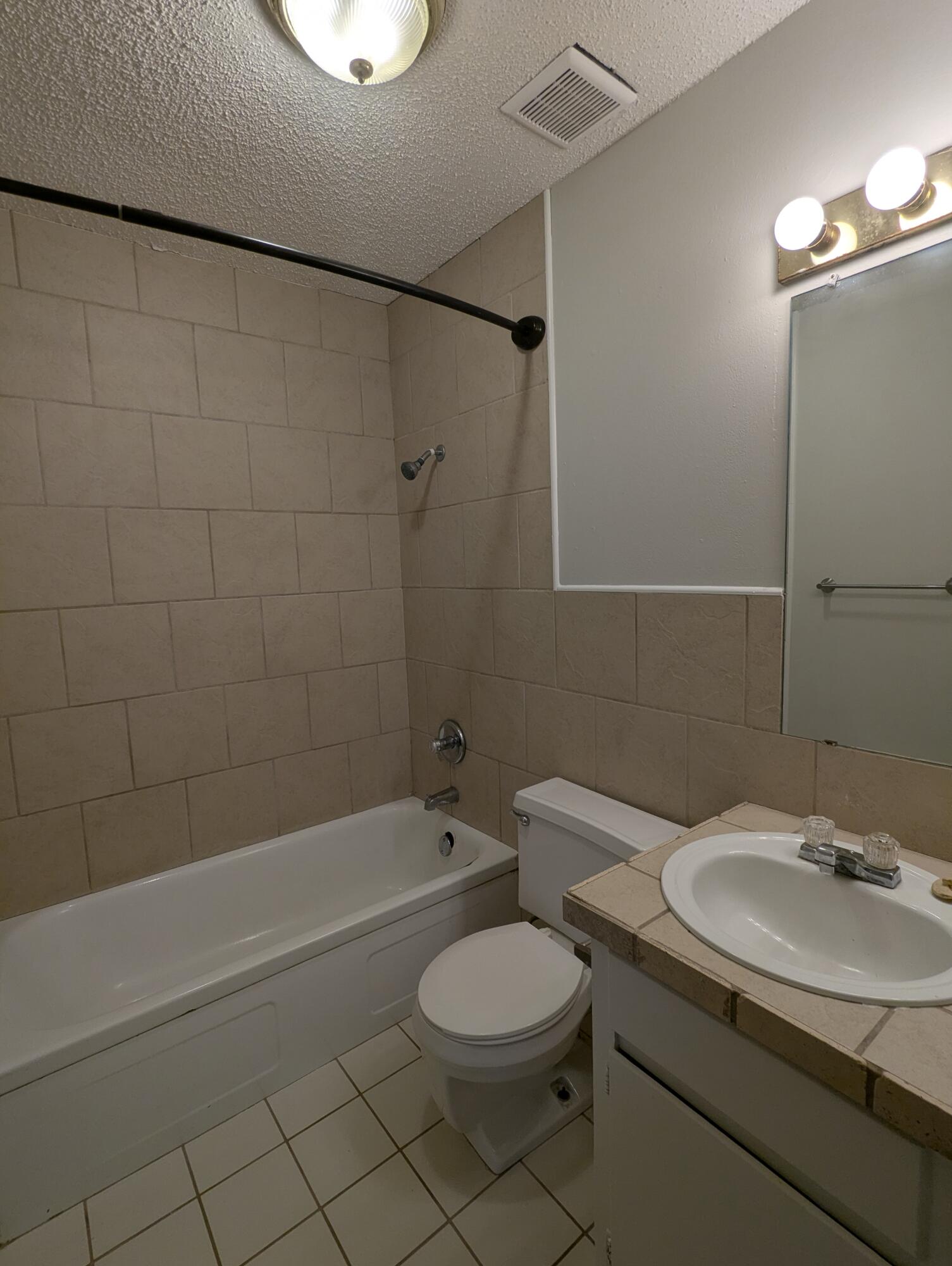 5416 36th Street Lubbock, TX 79407 - Photo 8 of 13 a bathroom with a sink toilet and shower