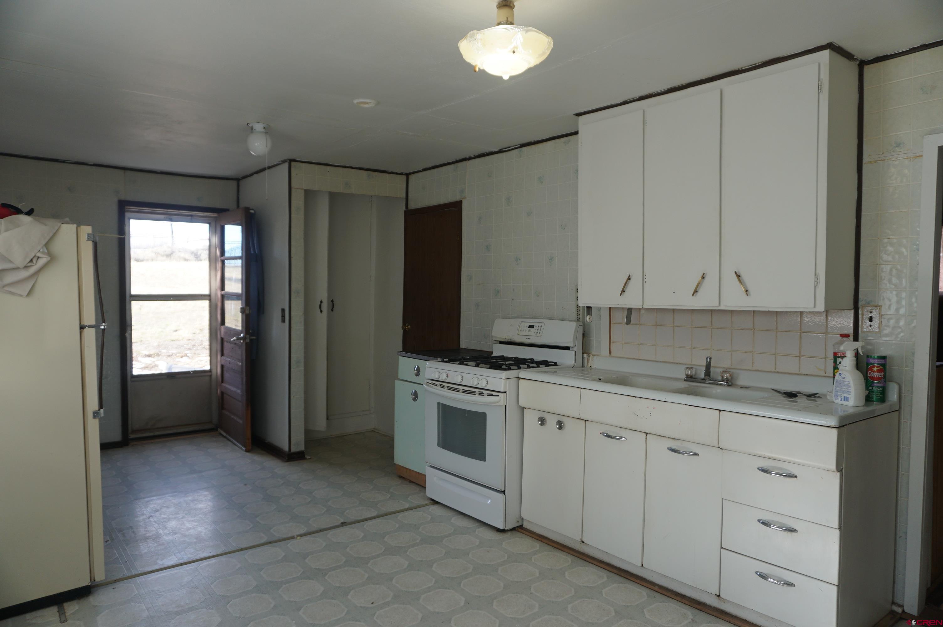 15297 Rd CC Pleasant View, CO 81331 - Photo 7 of 21 a kitchen with a sink cabinets and window