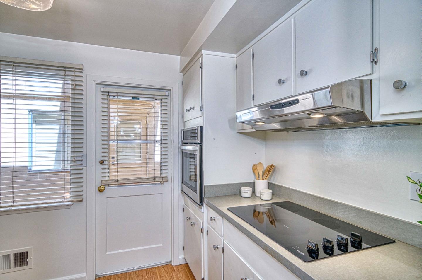 760 University Avenue Palo Alto, CA 94301 - Photo 12 of 25 a kitchen with stainless steel appliances cabinets a sink and a window